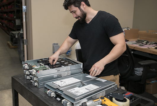 Server Parts Stacked on Table, Engineer Prepares Them