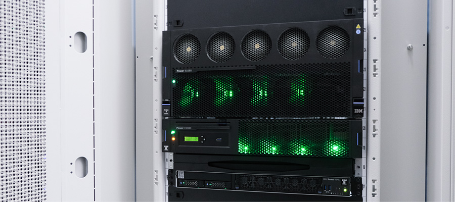 An image of IBM equipment close up with green lights illuminated