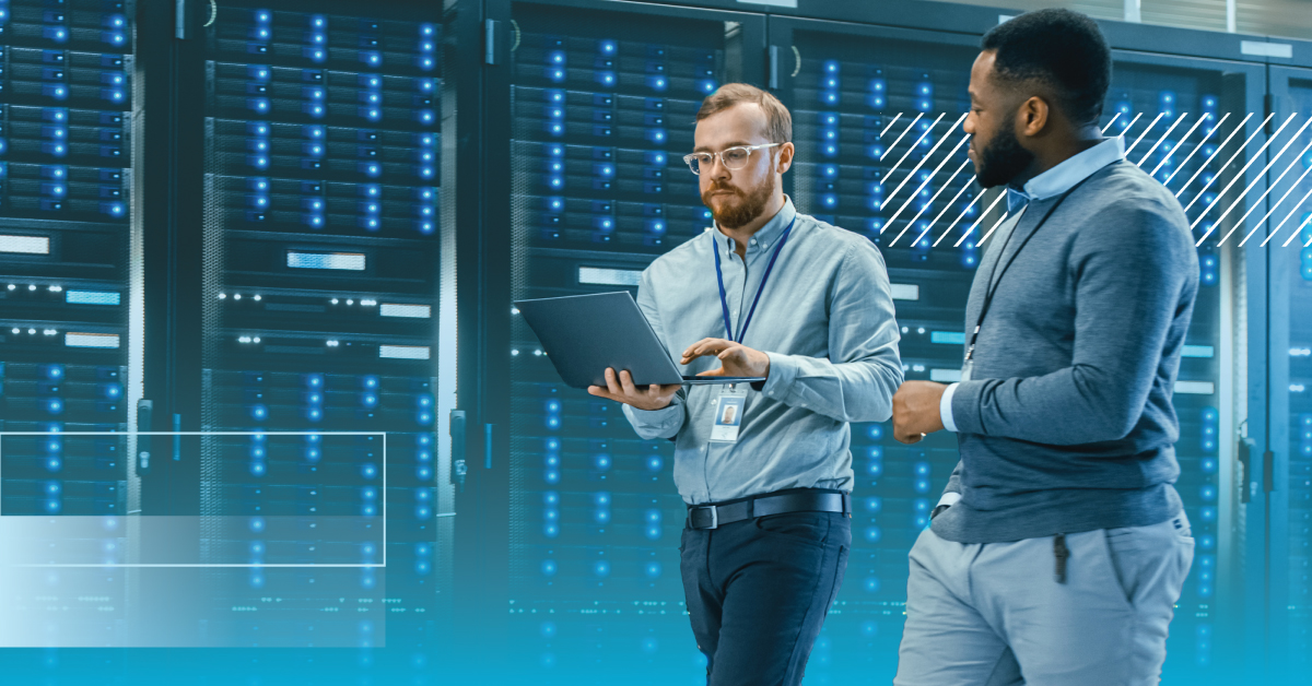 Two Professionals Walking with Laptop in Data Center