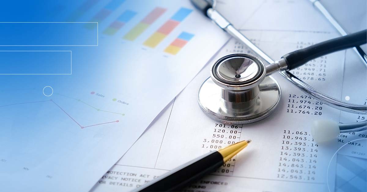 A close up image of a stethoscope and pen on top of some papers with charts on them