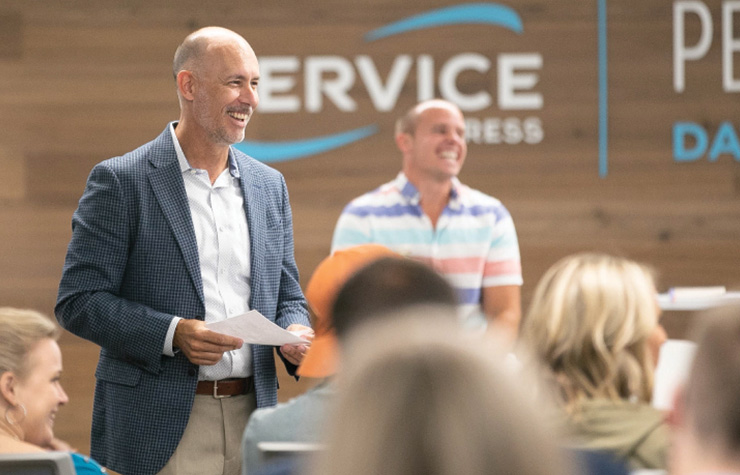 An image of Service Express leaders presenting and smiling