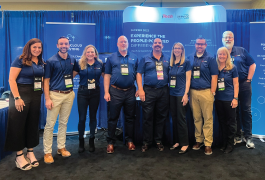 An image of the ITech team standing side by side at an event wearing matching blue polos