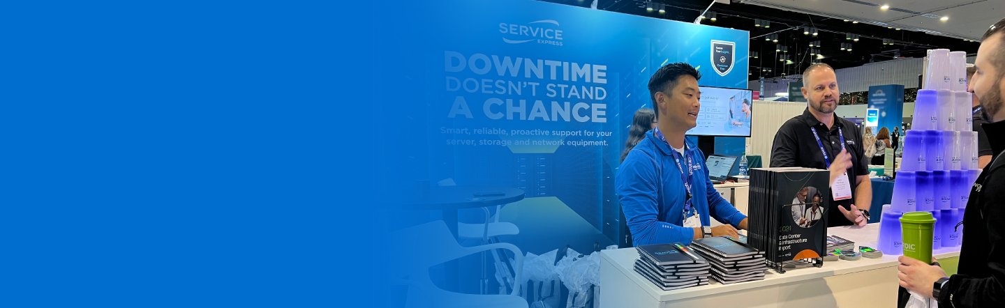 Service Express employees behind a tradeshow booth engaging with attendees