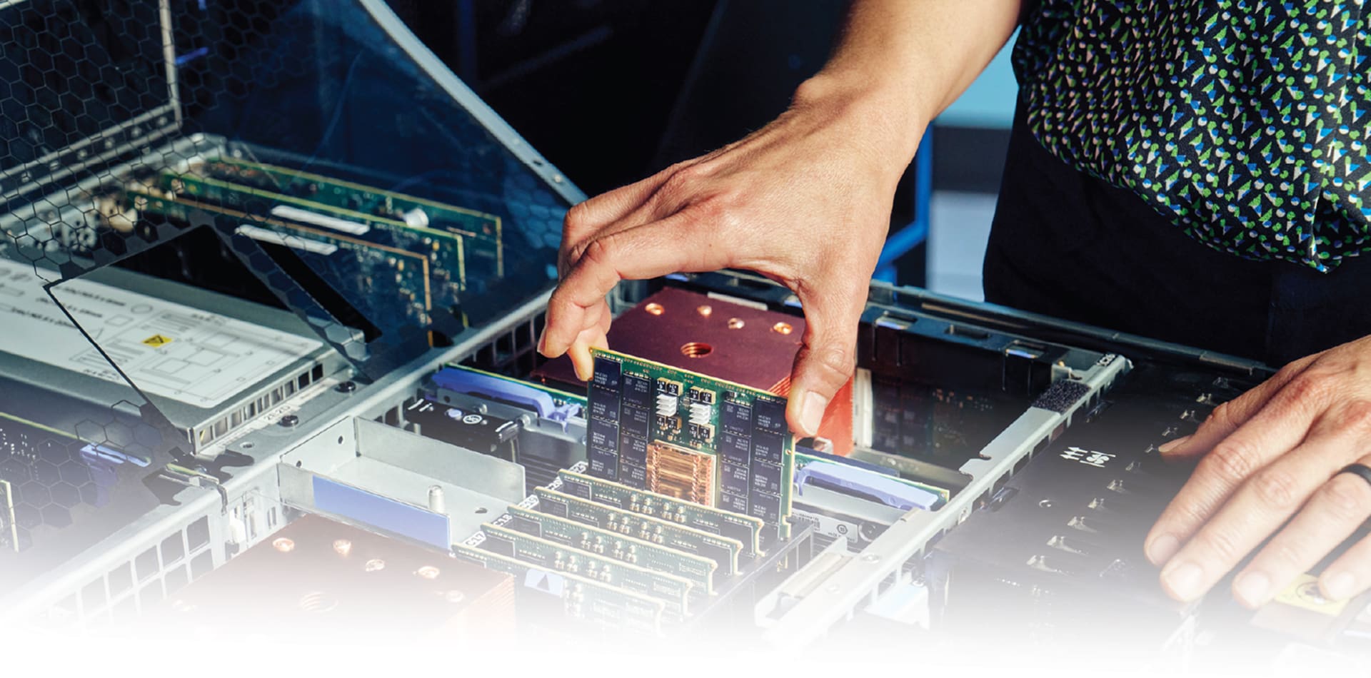 An image of the hands of an engineer replacing a circuit board